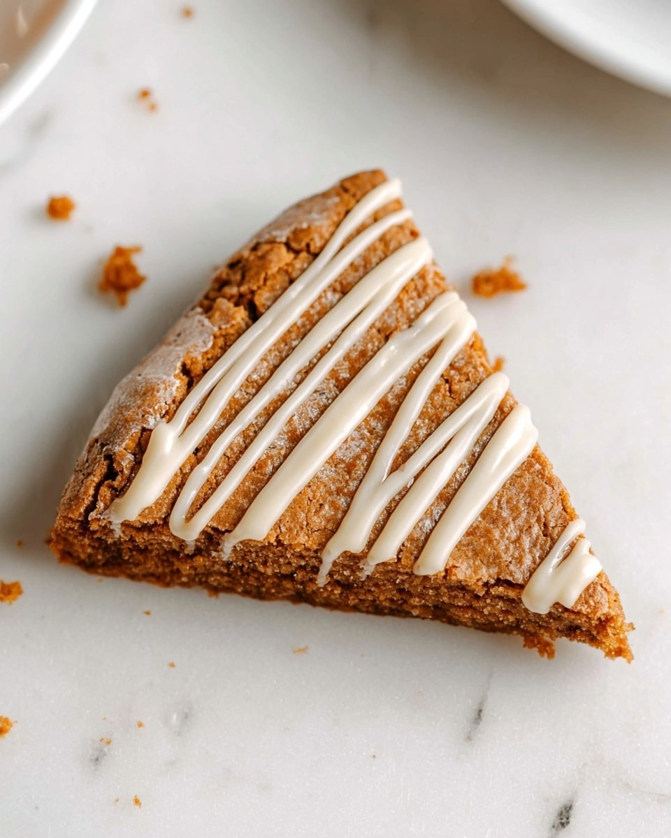 A close-up view of six triangular slices of a light brown cake arranged in a circular pattern on a white plate with a thin dark rim. Each slice has a rough, cracked surface texture and is topped with thin, uneven drizzles of white icing. The cake looks dense but soft, and the edges are slightly darker than the center. The plate sits on a white marbled surface. photo taken with an iphone --ar 4:5 --v 7
