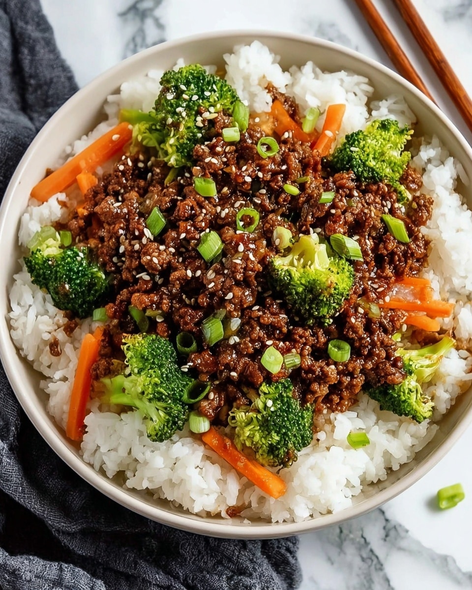 The dish is served in a white bowl and has three layers. The bottom layer is fluffy white rice, covering the entire base. The middle layer consists of bright green broccoli florets and thin, orange carrot sticks scattered evenly on top of the rice. The top layer is crumbled, dark brown cooked ground meat mixed with a thick glossy sauce, garnished with small white sesame seeds and chopped light green scallions. The bowl is placed on a white marbled surface next to wooden chopsticks and a piece of dark cloth. Photo taken with an iphone --ar 4:5 --v 7